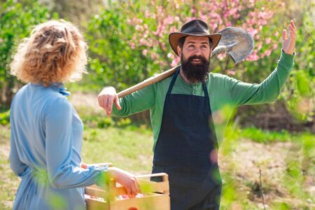Farmers couple working in field. Portrait of pair of farms Working In Garden Together. Couple in the farm on countryside background.の写真素材