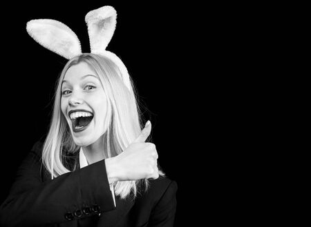 Fashion studio photo of sexy beautiful girl with blond hair with bunny ears. Hunting eggs. Rabbit woman wearing ears. Sexy woman wearing a mask Easter bunny and looks very sensually.の写真素材