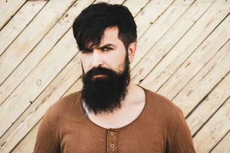 Guy with beard and modern hairstyle on street. Handsome male model - beard mustache and hairdo wears casual shirt.の写真素材
