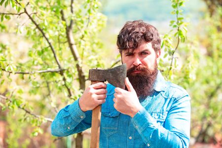 Portrait of bearded farmer with axe. Agricultural Land. Spring and hobbies. Gardener. Eco farm...