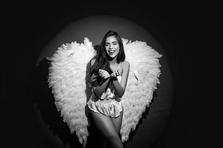 Angel woman with wings isolated. Romantic young beauty as an angel. Angel with gift. Angel girl. Happy Valentines Day.の写真素材