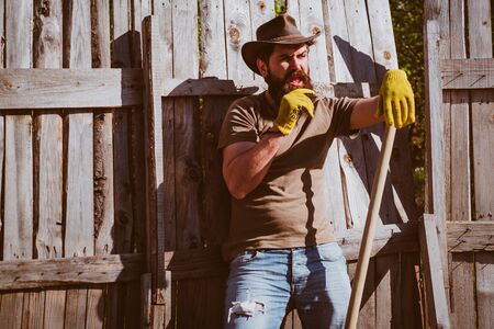 Cowboy portrait. Farmer planting in the vegetable garden. Agricultural Land.の写真素材
