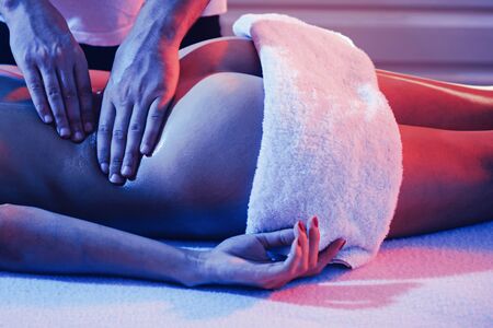 Professional massage at home. Ideal womans butt anti-cellulite and skin care. Massage and body care. Massage Therapy for Health Purposes. Massage Oils and Scented Body Oil. Relax.の写真素材