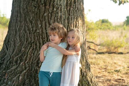 Funny little girl and boy. Happy children in summer in nature. Happy day. Happy brother and sister....
