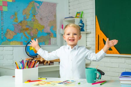 Schoolkid or preschooler learn. Little student boy happy with an excellent mark. School interiors....