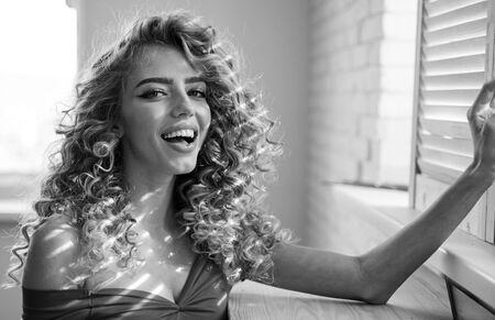 Beautiful woman. Shiny curly hair . Beautiful model woman with wavy hairstyle.の写真素材