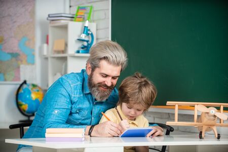 Concept of education and reading. After school teaching. Private child tutor. Elementary school. Back to school. Elementary student. Elementary school tutor.の写真素材