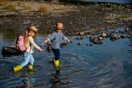 Little children on river. Summer camp. Children summer activities. Children fun. Every childhood matters.の写真素材
