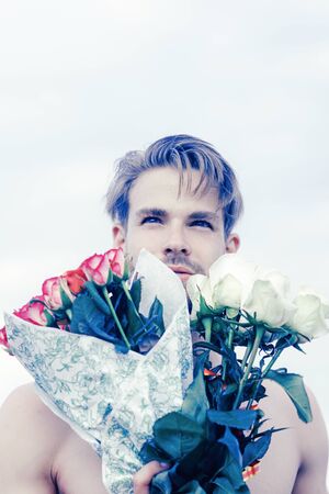 romantic man with rose bouquet. valentines day present. gift with love. ready for date. muscular macho man with flowers. Love you more than yesterday. man in love. birthday present. party celebrationの写真素材
