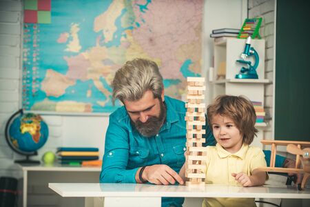 Father and son playing stacking wood blocks games for meditation practice. Kids Skills.の写真素材
