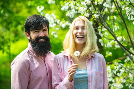 I Love You. Passion and sensual touch. Happy couple smiling in a spring park on a sunny day....