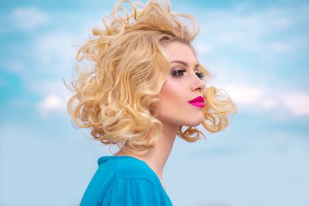 Beauty Salon. Blond woman with curly beautiful hair. Beauty Model girl with Healthy Hair.