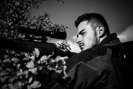 Close up snipers carbine at the outdoor hunting.Hunting in America. Deer hunt. Hunter with shotgun...