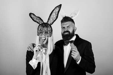 Funny easter. Cute bunny rabbit couple. Easter bunny dress. Happy easter egg couple eat carrot.