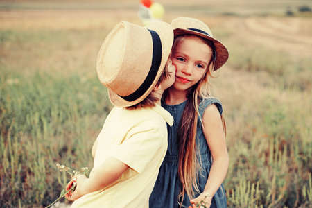 Child playing Happy childhood. Love concept. Romantic and love. Sweet angel children. Kid having fun in spring field. Valentines day card.の写真素材