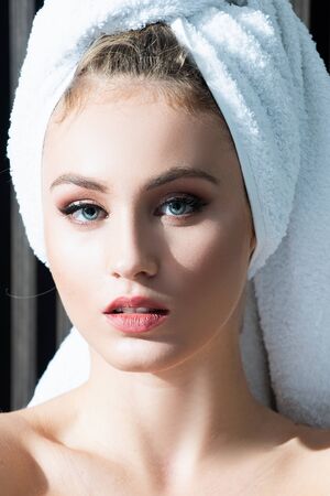 Close up portrait of woman posing wrapped in bathroom towels, Beauty portrait of a cheerful...