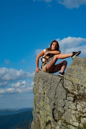 Woman traveler looking at amazing mountains and forest. Travel concept, space for text. Atmospheric epic moment Travel recreational outdoor activity concept. Camping.の写真素材