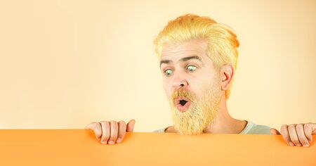 Close up portrait of excited man showing plain blank sign.の写真素材