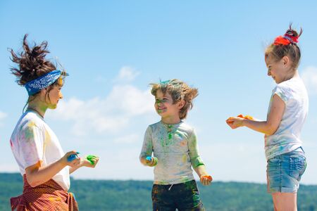 Kids playing colours. Holi festival of colors. Kids with face smeared with colors. Child girls and...