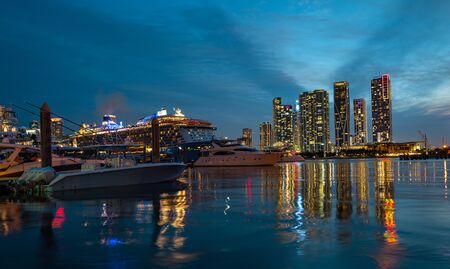 Cruise ship and Downtown skyscrapers in Miami. Miami skyline of downtown night colorful skyscraper...