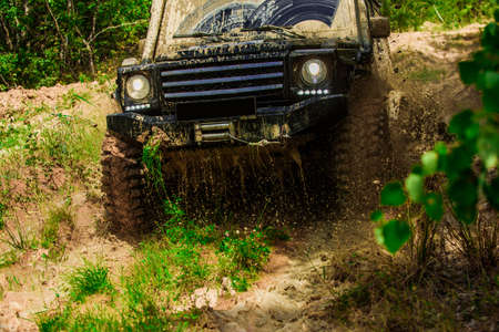 Motion the wheels tires and off-road that goes in the dust on the sand. Off-road vehicle goes on...