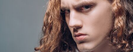 Young man tense face on grey background. Cropped photo of sporty handsome strong sporty perfect seductive confident man. Portrait casual serious man.Confident concept. Urban lifestyle concept.の写真素材