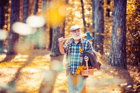 Sunny weather. Portrait of aged man with beard. Mature man with beard in hat. Outdoor portrait. Woodman in forest. Human and nature. Funny bearded man. Natural background. Rest in forest.の写真素材