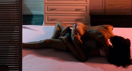 Prelude couple in love. Intimate relationship and sexual relations. Sexually explicit. Erotic and spiritual feeling. Attractive man and woman being playful.の写真素材