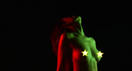 sexy woman with bare chest hidden with stars. Passion art. copy space. silicone implants. biggest...