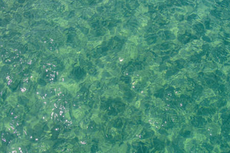 Soft blue ocean wave on sandy beach. Beautiful sea summer or spring abstract background.の写真素材