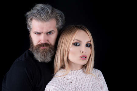 Sensual portrait of young stylish fashion couple posing on black background.の写真素材