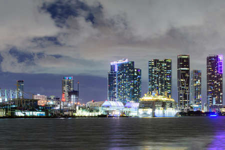 Miami skyline. Cruise ship in the Port of Miami at sunset with multiple luxury yachts. Beautiful Miami Florida skyline at sunset.の写真素材