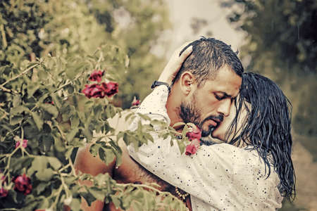 Love in the garden. Passionate couple in the garden hugging.の写真素材