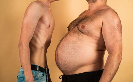 Obesity and weight loss. Fat vs skinny. Comical and funny fat and thin man.の写真素材