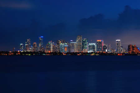 Skyline city miami lighting lights sea ocean sunset night cityscape buildings downtown, architecture skyscraper dusk panorama. Miami.の写真素材