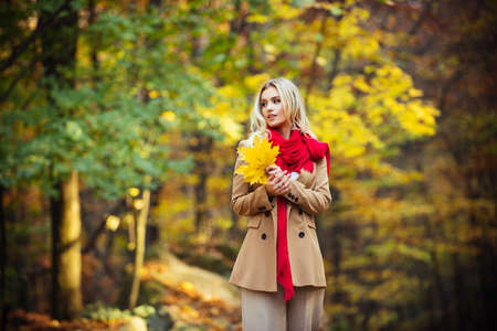 Young fashion woman in autumn color dress.