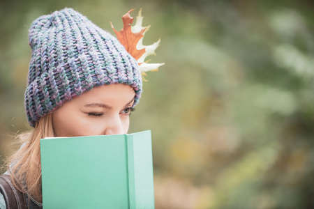 Woman writer. Female face with notebook outside, close up.の写真素材