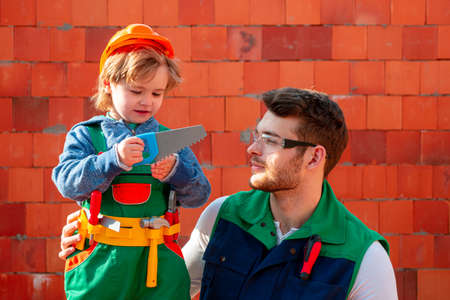 Child and brother dreaming about future career in architecture or building. Childhood concept. Tools construction. Carpenter tools.の写真素材