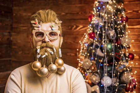 Santa in barbershop. Christmas or New Year barber shop concept. Beard with bauble. Christmas style for modern Santa.の写真素材