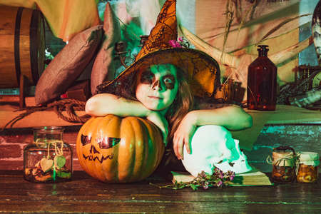 Halloween interior. Halloween decorations. Halloween child. Funny face. Happy Halloween Cute girl...