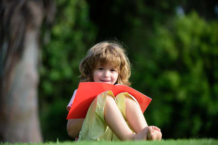 Distance children learning using pencil to practice writing on a book. Kid learning to write,...