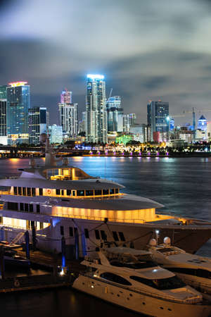 Miami Florida at sunset, skyline of illuminated Yacht or boat. Miami city night.の写真素材