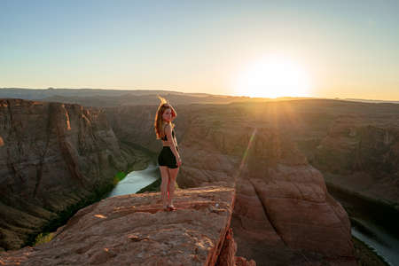 Carefree woman on Grand canyon. Woman enjoying view of Horseshoe bend. Travel Lifestyle adventure vacations concept.の写真素材
