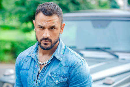 Casual urban style. Serious face. Portrait of thinking man outdoor.