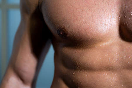 Sexy torso of a muscular male model. Guy with sexy body. Chest, breast of muscular man. Close up...