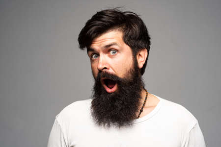 Surprised handsome bearded man in shocked. Surprise expression, wow amazed excited face. Emotions people concept.の写真素材