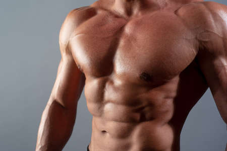 Handsome young mans torso closeup. Sexy naked torso, six pack abs.