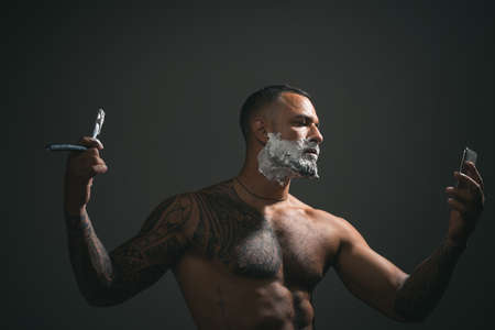 Barber shop tools on old wooden background with copy space. Barber shop. Portrait of stylish man beard. Master hairdresser does hairstyle and style with scissors and comb. Fine Cuts.の写真素材
