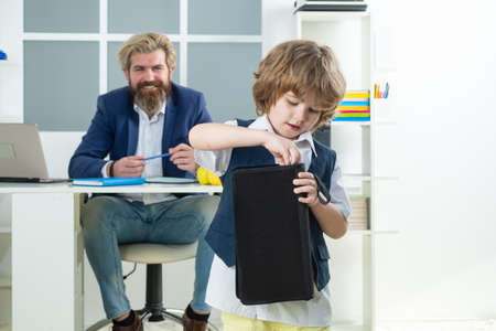 Little boss. Little Businessman bossy child working in office. Business people talking and discussing. Future career.の写真素材