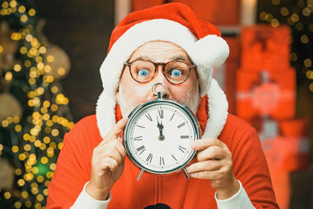 Happy new year. Santa Claus with real beard holding clock. Happy Christmas Santa with clock. Photo...